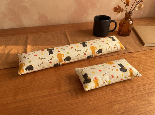Autumn black cat keyboard and mouse wrist rests on a wooden desk with a black mug and autumn leaves