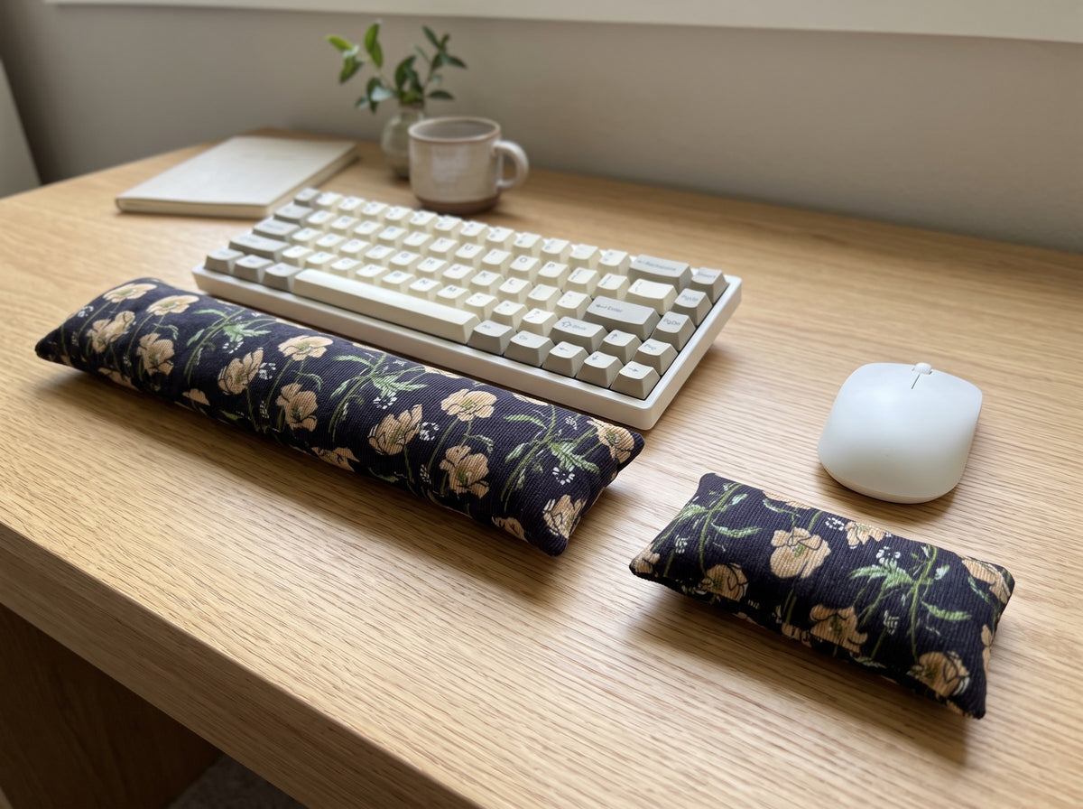 Black poppy corduroy wrist rest set in front of a keyboard and mouse