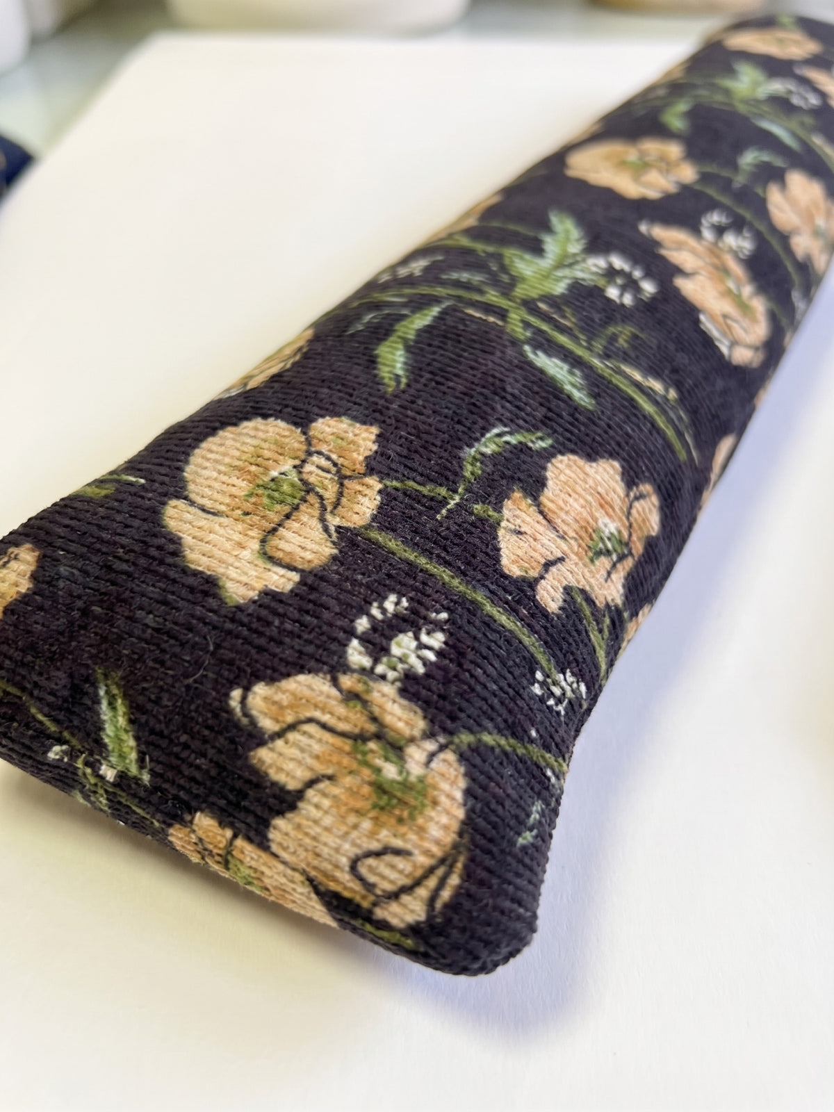Close-up of the peach poppies on the dark ribbed corduroy
