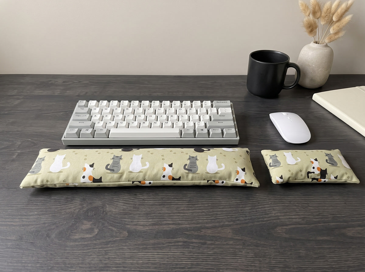 Sage green cat print keyboard and mouse wrist rests with a keyboard, mouse and mug