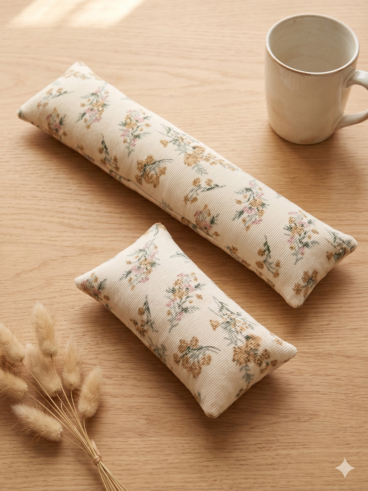 The two pieces of the cream floral corduroy set, a keyboard wrist rest and a mouse wrist rest