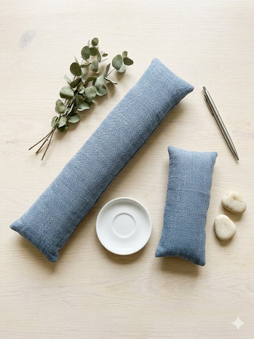 The two pieces of the denim blue set, a keyboard wrist rest and a mouse wrist rest, with eucalyptus