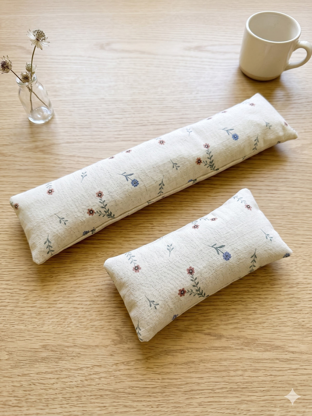 The two pieces of the ditsy floral linen set, a keyboard wrist rest and a mouse wrist rest