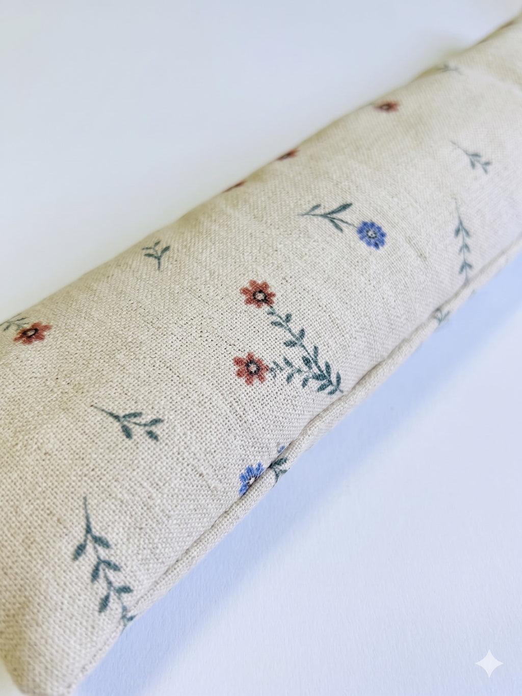 Close-up of tiny red and blue flowers on natural linen