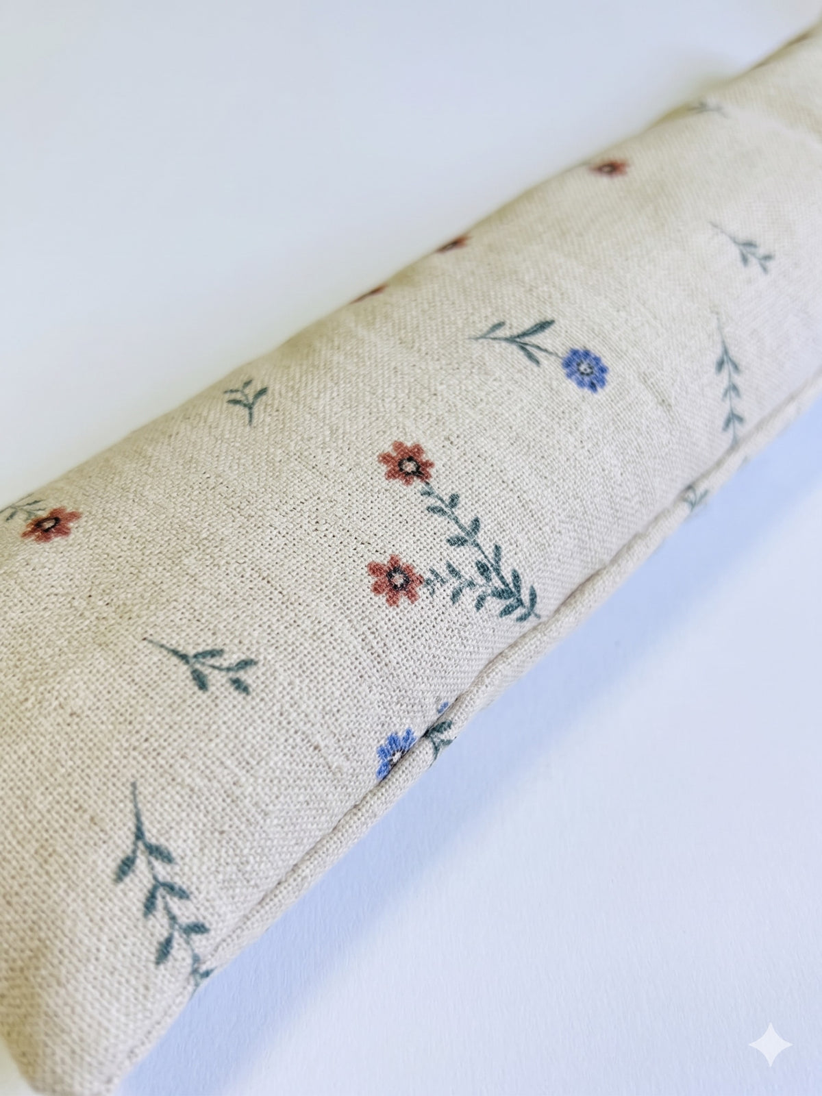 Close-up of tiny red and blue flowers on natural linen