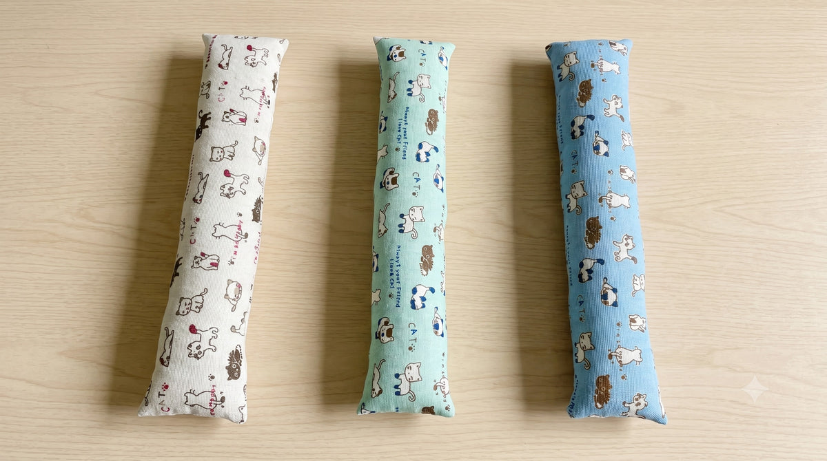 Three doodle cat keyboard wrist rests side by side in natural, mint and sky blue