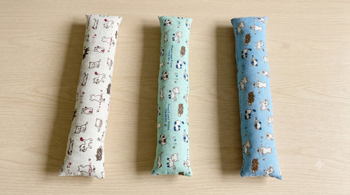Three doodle cat keyboard wrist rests side by side in natural, mint and sky blue
