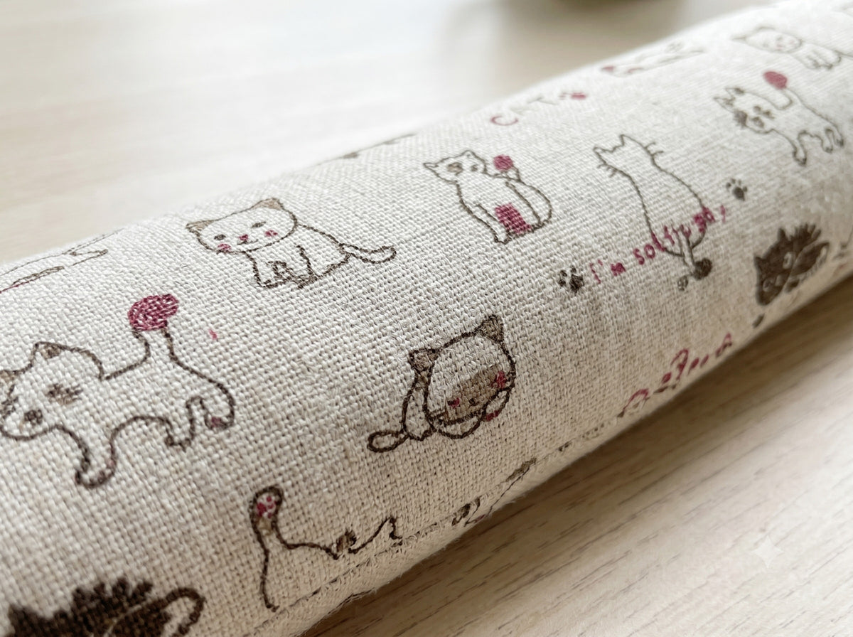 Close-up of the little doodled cats on the natural cover
