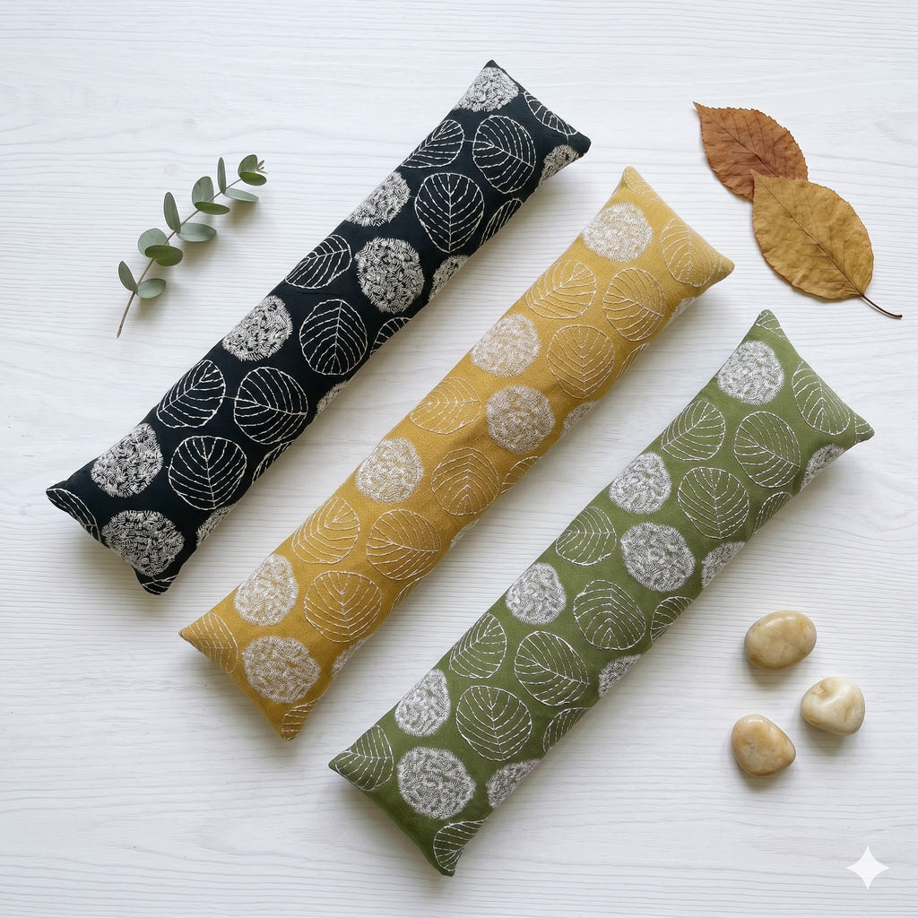 Embroidered leaf keyboard wrist rests in black, mustard yellow and olive green side by side
