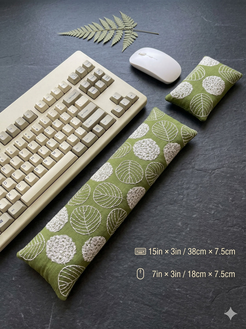 Green embroidered leaf keyboard rest, 15 × 3 in, and mouse rest beside a keyboard and mouse