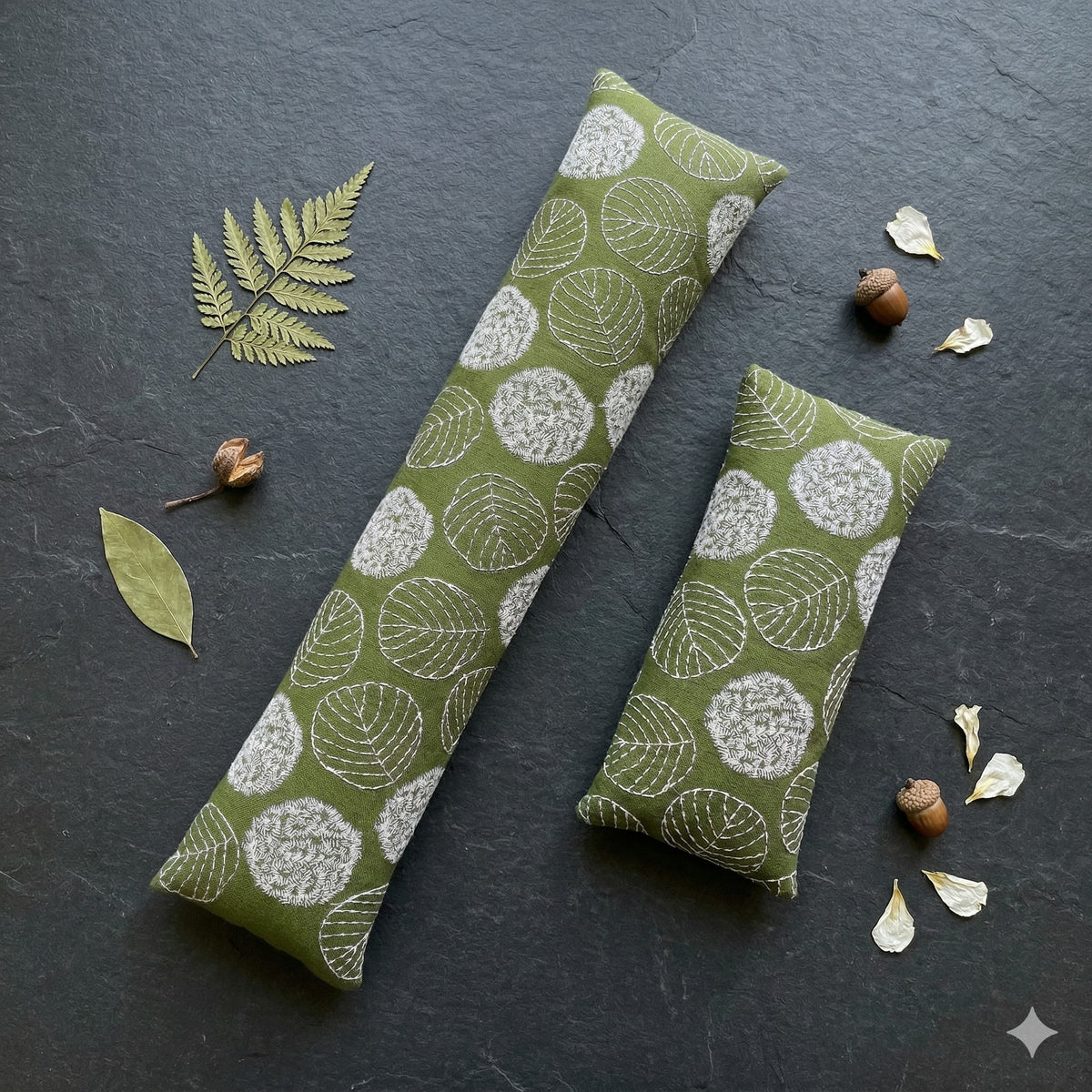 Olive green embroidered leaf keyboard and mouse wrist rests on dark slate