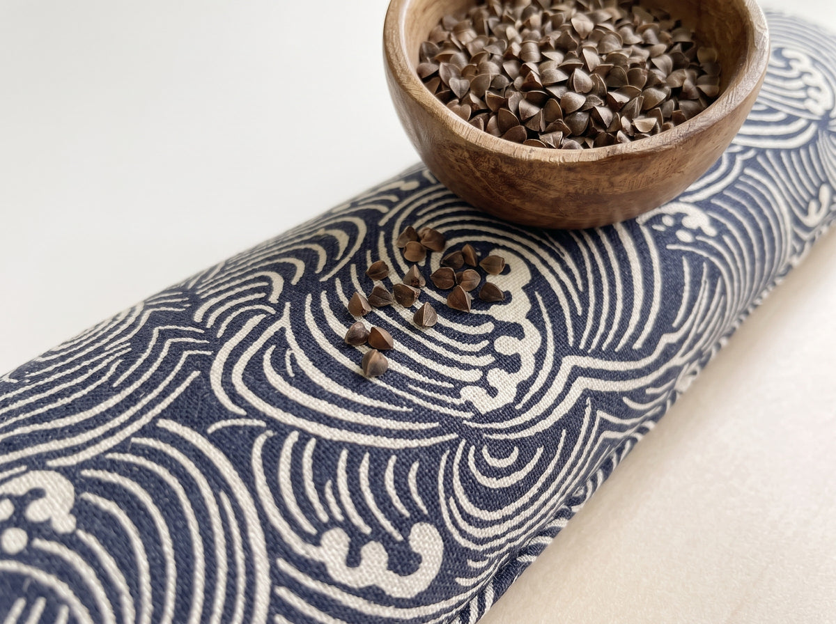 Close-up of the indigo wave print beside a bowl of buckwheat hulls used as filling