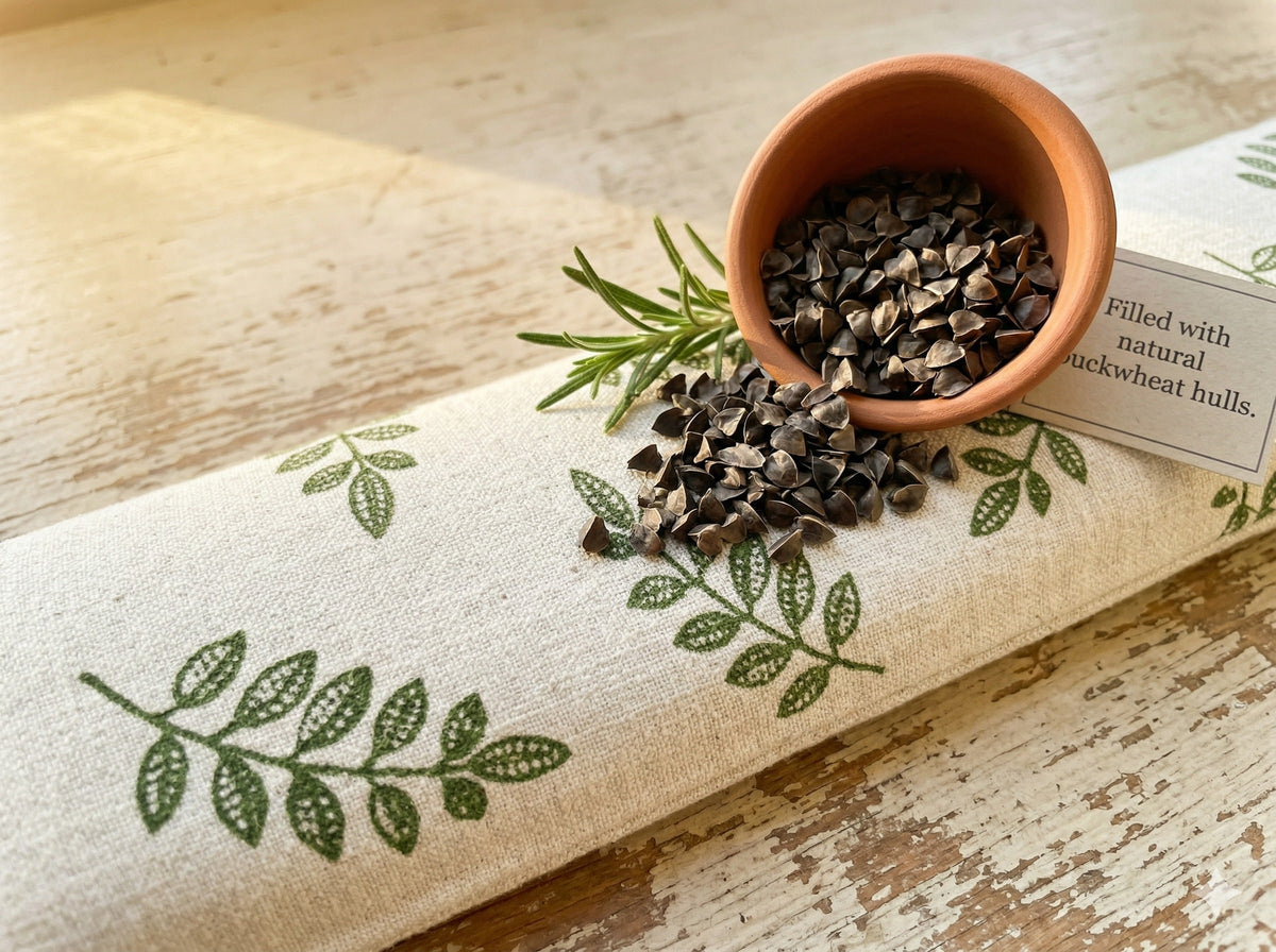 Close-up of the green leaf print with a small pot of buckwheat hulls and rosemary