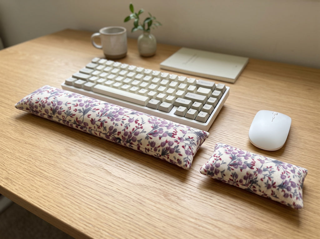 Lilac floral corduroy wrist rest set in front of a keyboard and mouse