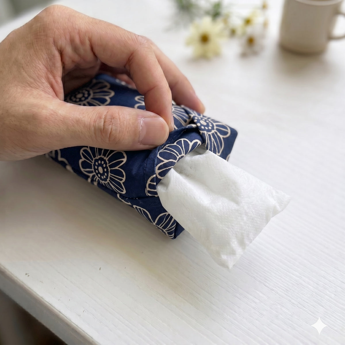 Hand sliding the white inner bag of buckwheat hulls out of the navy daisy cover