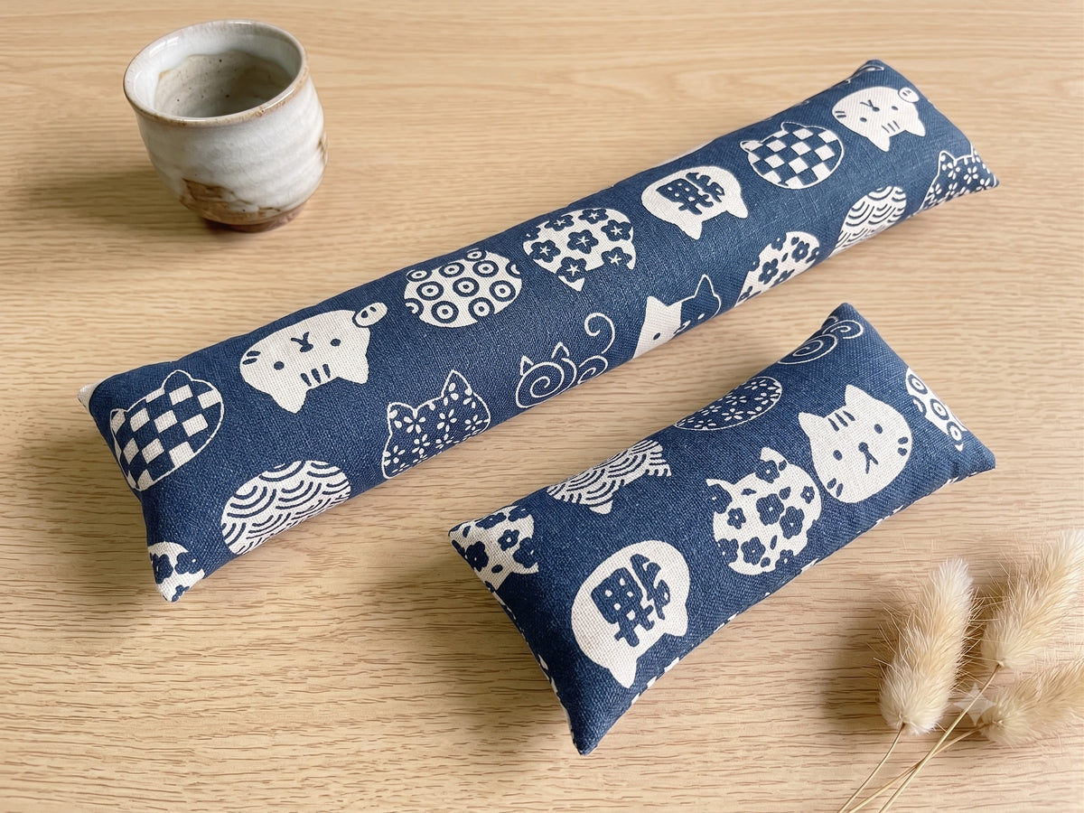 The two pieces of the blue lucky cat set, a keyboard wrist rest and a mouse wrist rest