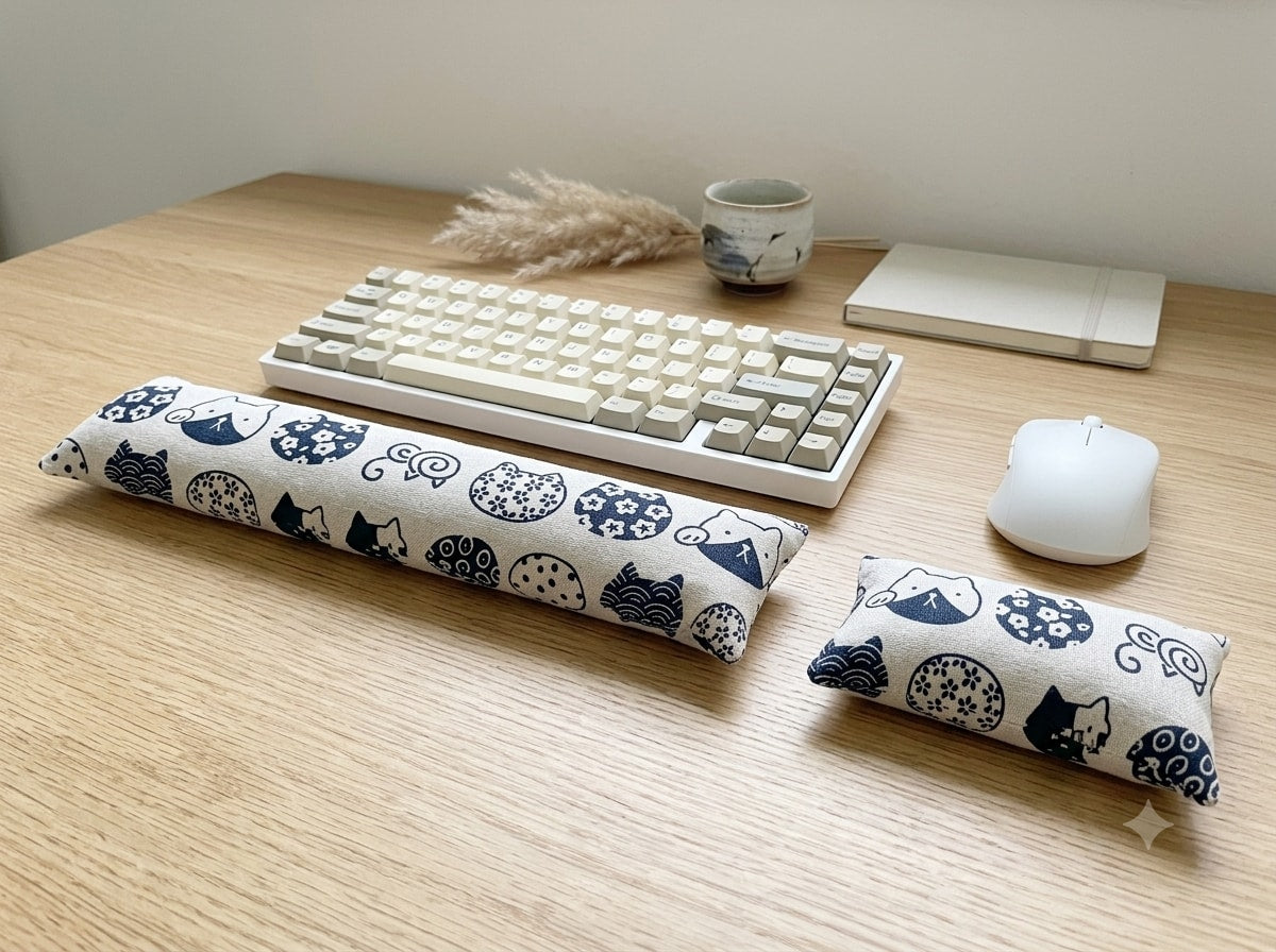 White Maneki Neko wrist rest set with indigo cats in front of a keyboard and mouse