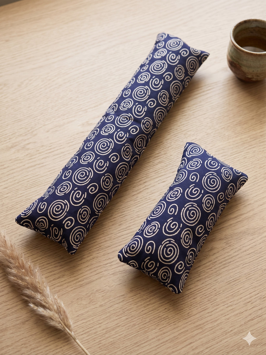 Indigo blue spiral keyboard and mouse wrist rests on a wooden desk