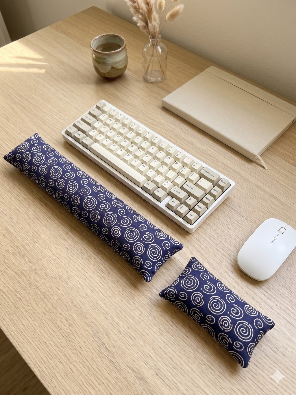 Blue spiral wrist rest set around a keyboard and mouse on a wooden desk