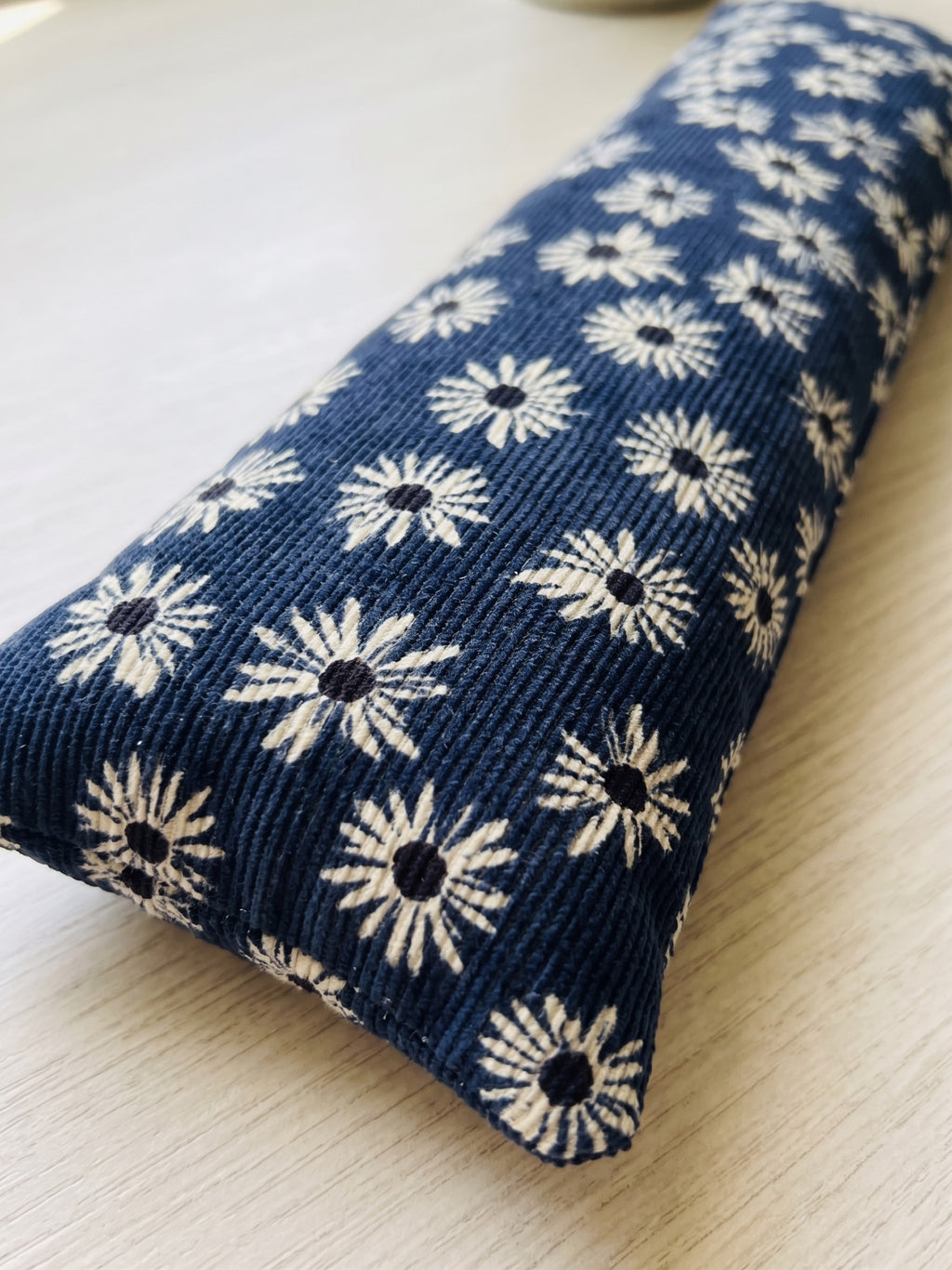 Close-up of the white daisies on the ribbed navy corduroy