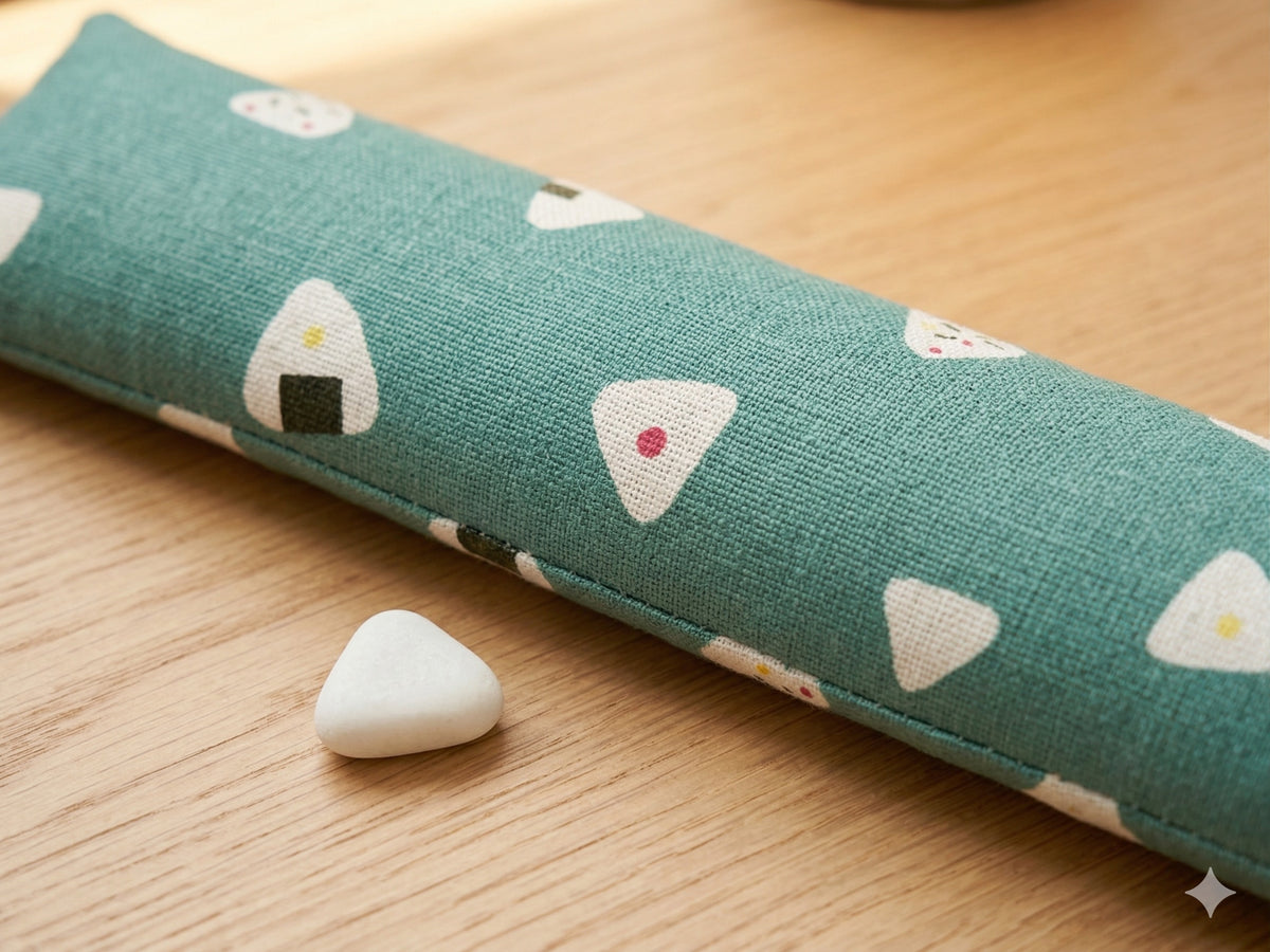 Close-up of the rice ball print on teal fabric