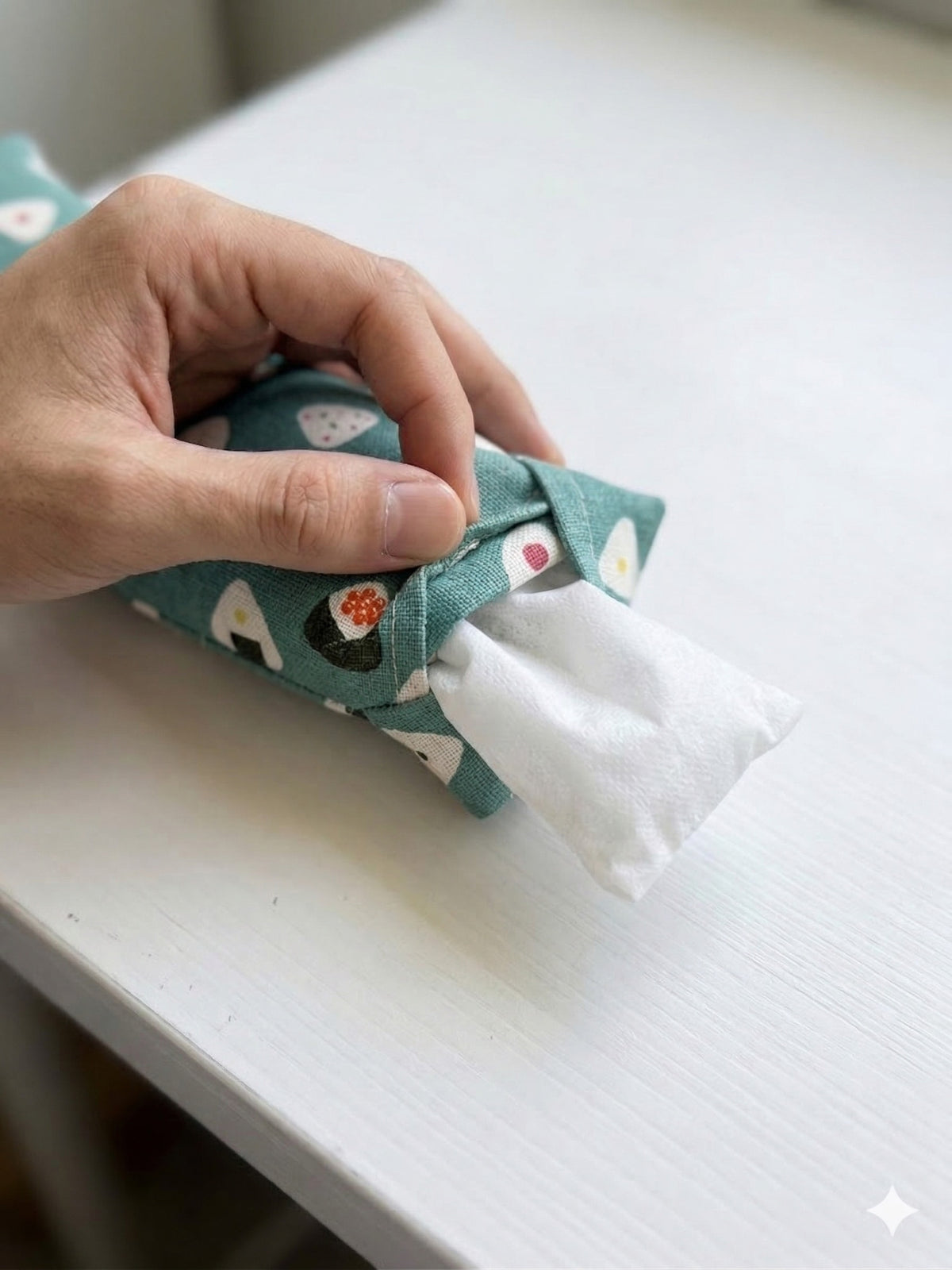 Hand sliding the white inner bag of buckwheat hulls out of the onigiri print cover