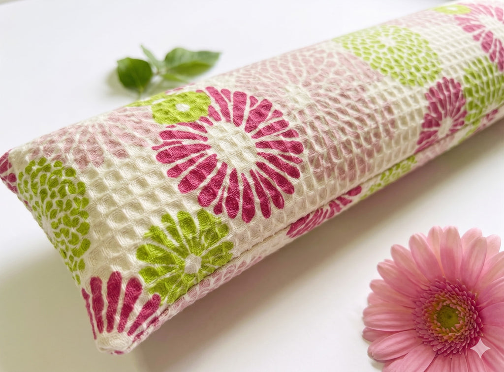 Close-up of the pink and green flowers on the waffle-weave cover