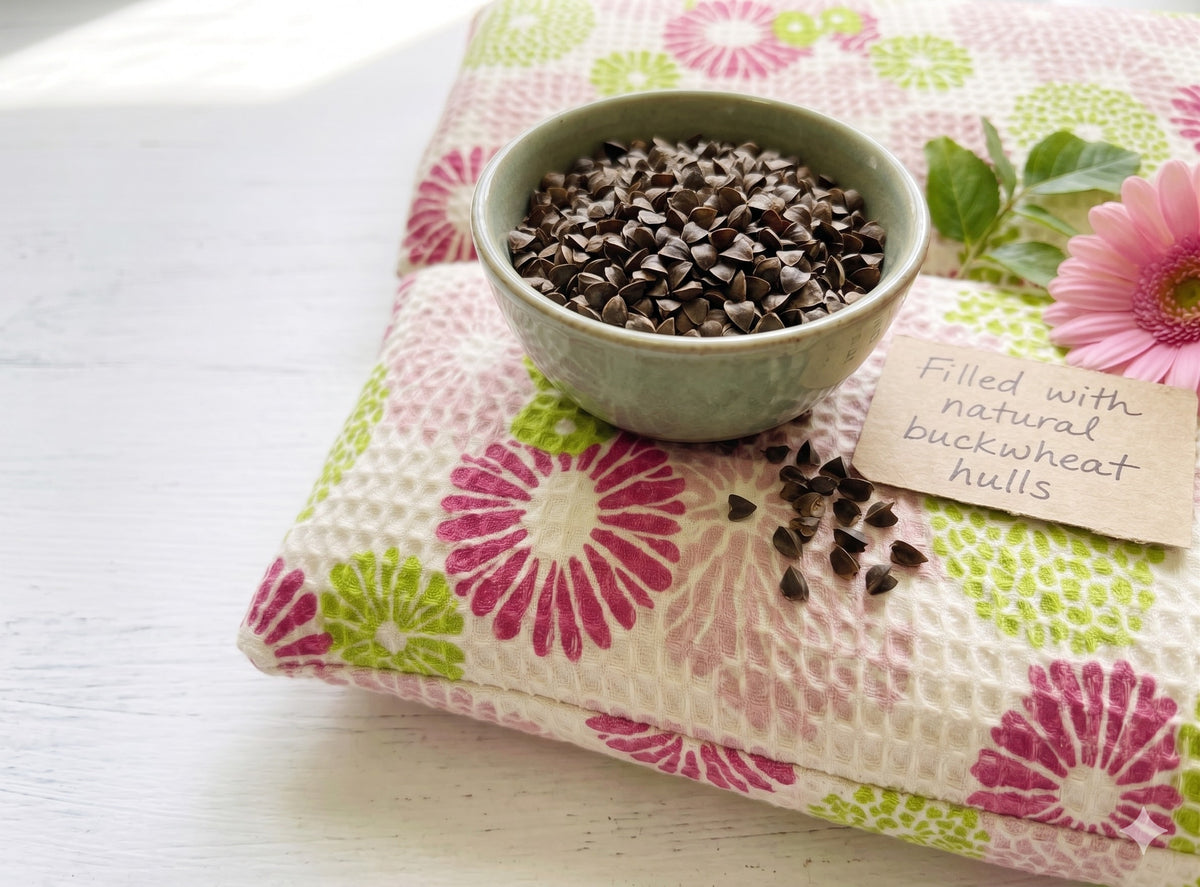 Pink floral wrist rest under a bowl of buckwheat hulls, the natural filling