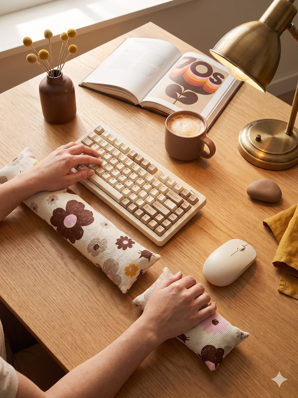 Hands typing on a keyboard above the mocha retro floral cat wrist rest