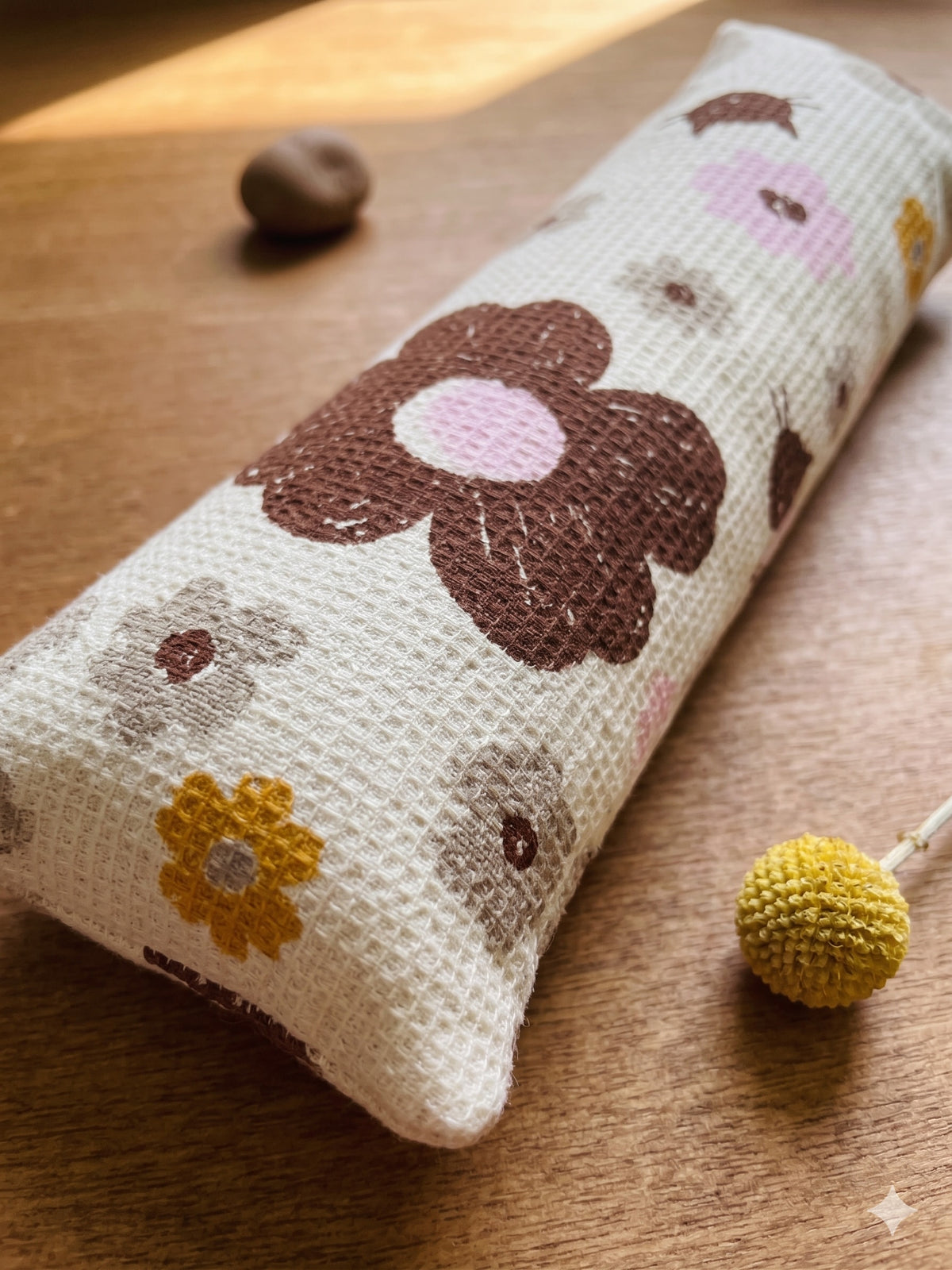 Close-up of the chocolate, blush and mustard flowers on the mocha waffle-weave cover