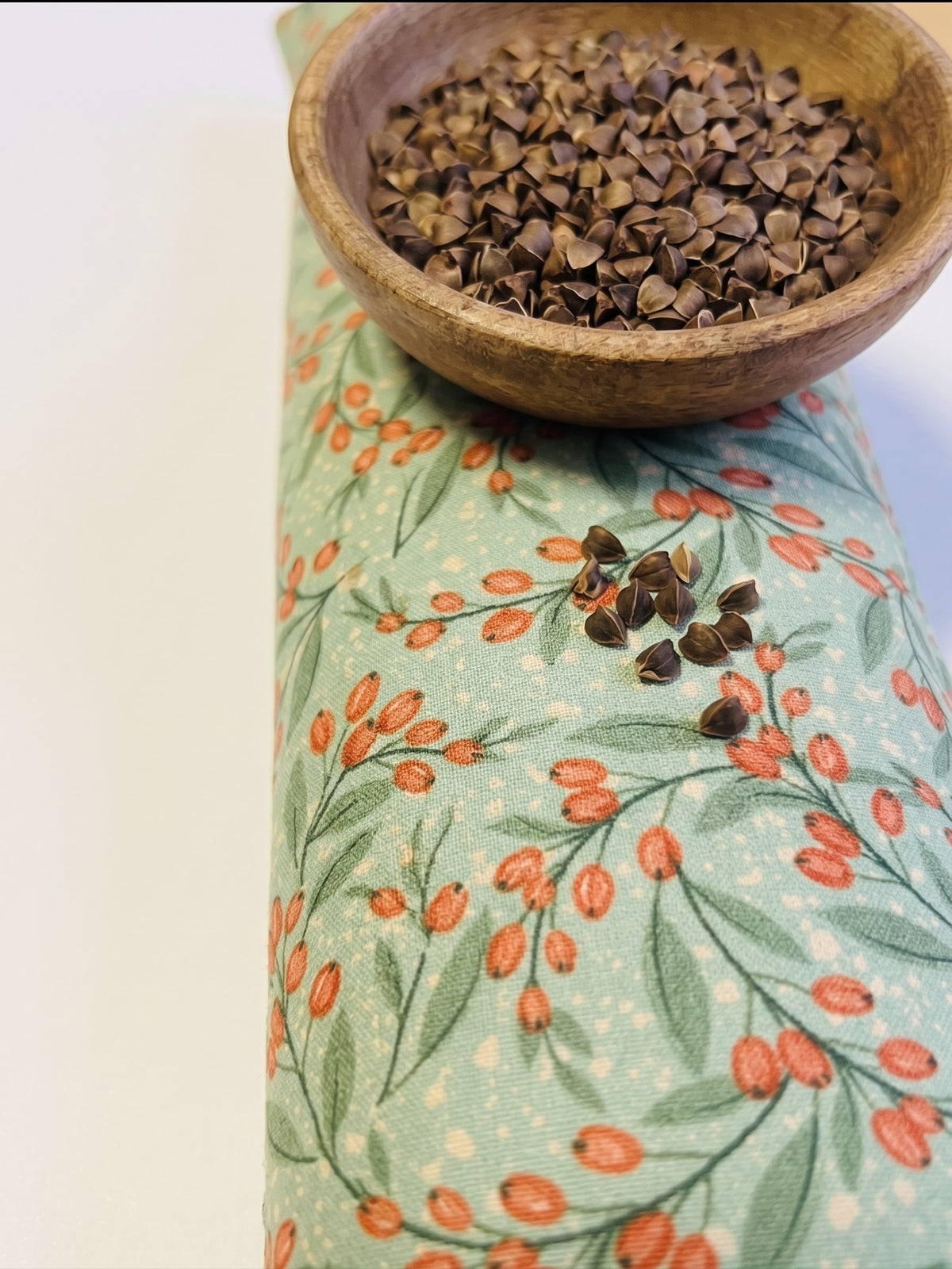 Sage berry wrist rest with a bowl of the buckwheat hulls used as filling