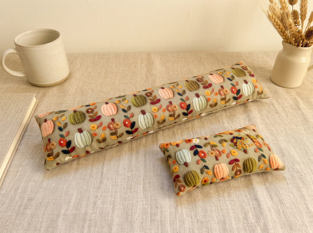 The two pieces of the sage pumpkin floral set, a keyboard wrist rest and a mouse wrist rest