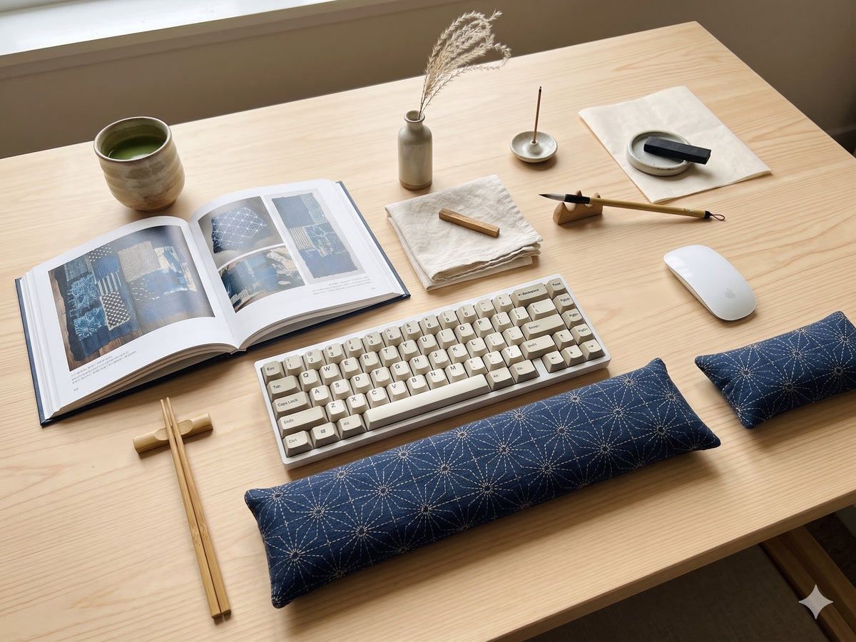 Sashiko asanoha wrist rest set in front of a keyboard on a desk with an open book and chopsticks