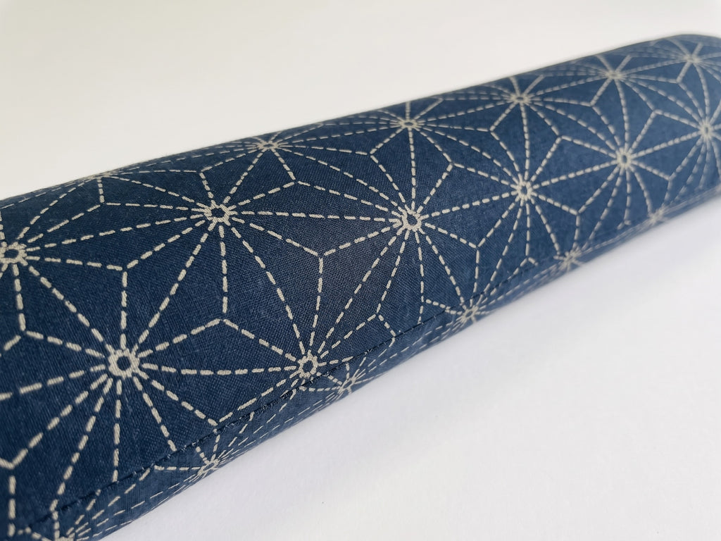 Close-up of the white asanoha hemp-leaf star pattern on deep indigo