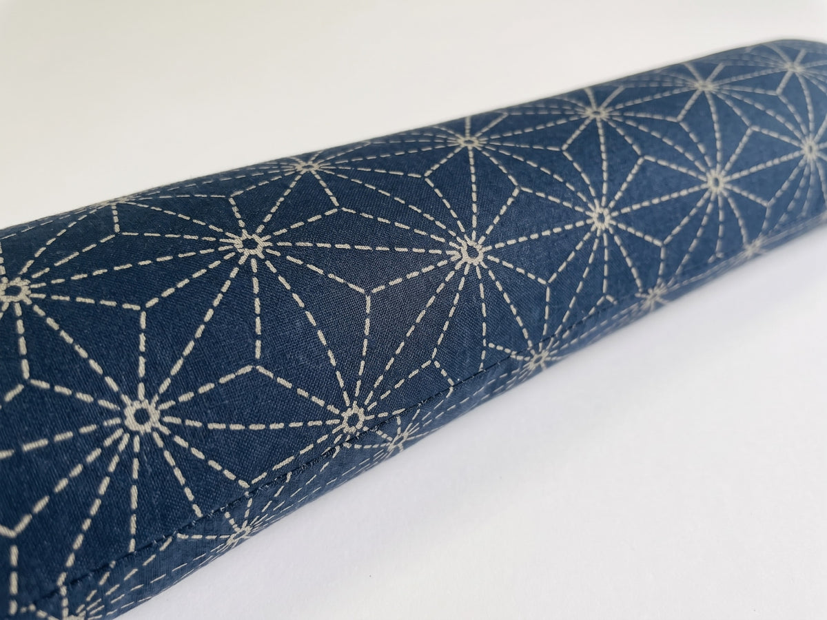 Close-up of the white asanoha hemp-leaf star pattern on deep indigo