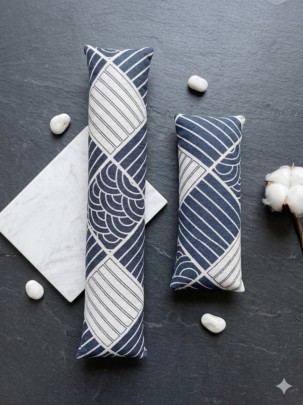 The two pieces of the sashiko boro set laid flat on dark slate with marble and cotton stems