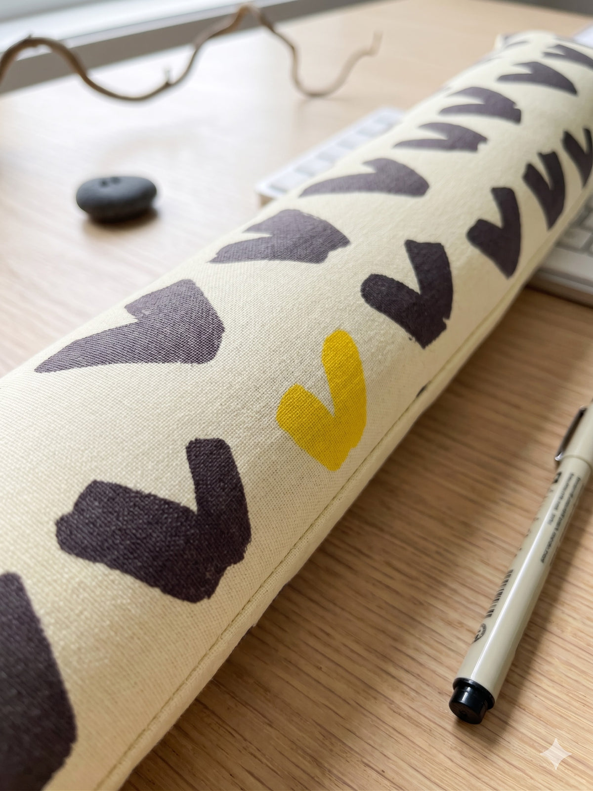 Close-up of the charcoal and mustard marks on the cream cover
