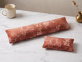 Terracotta bloom velvet keyboard and mouse wrist rests on a white marble desk