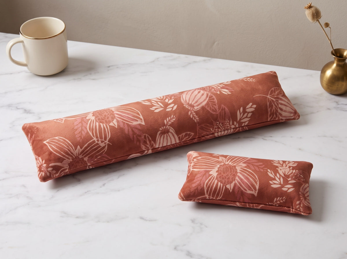 Terracotta bloom velvet keyboard and mouse wrist rests on a white marble desk