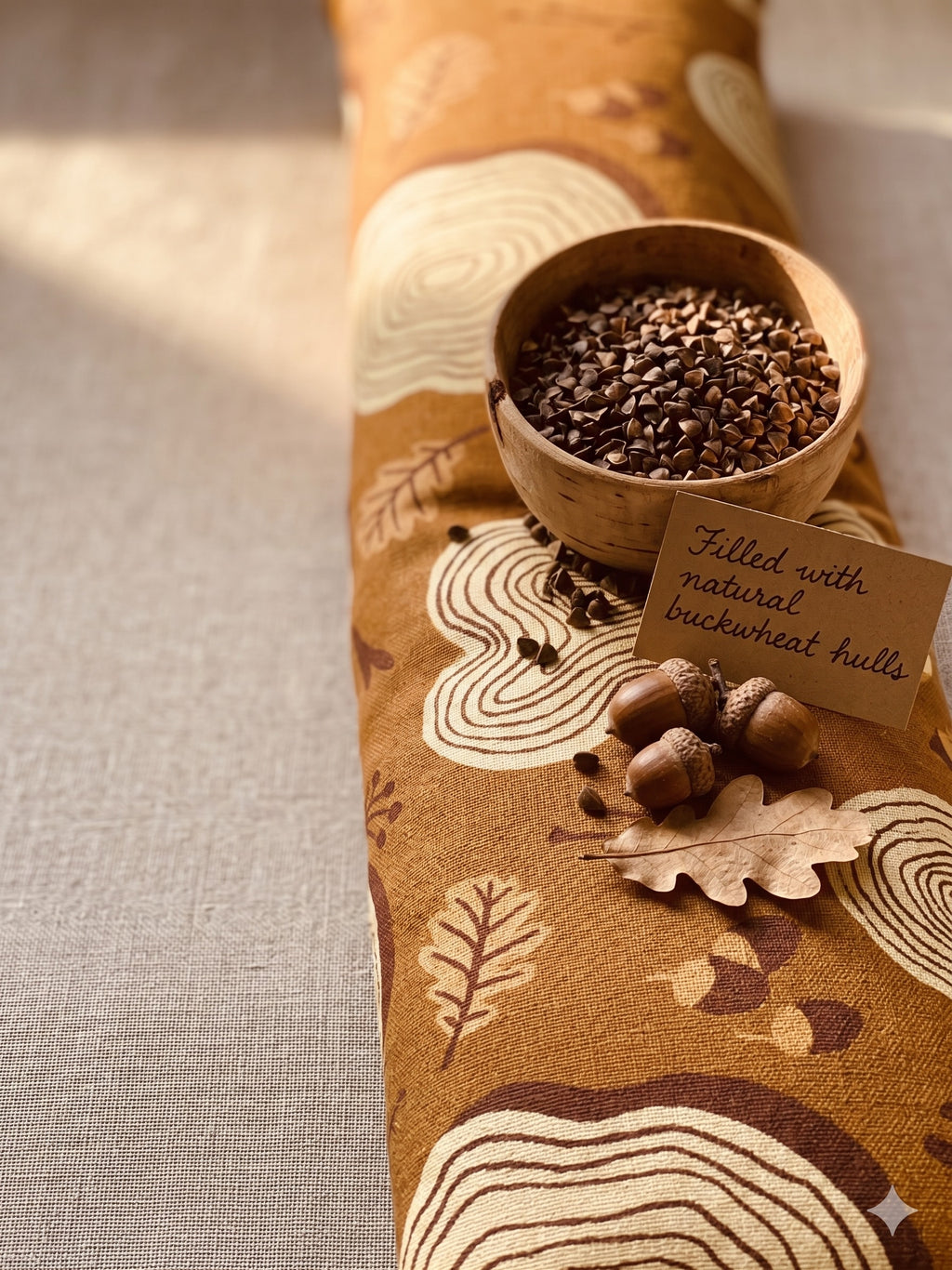 Tree ring wrist rest with a bowl of buckwheat hulls, acorns and a card that reads filled with natural buckwheat hulls