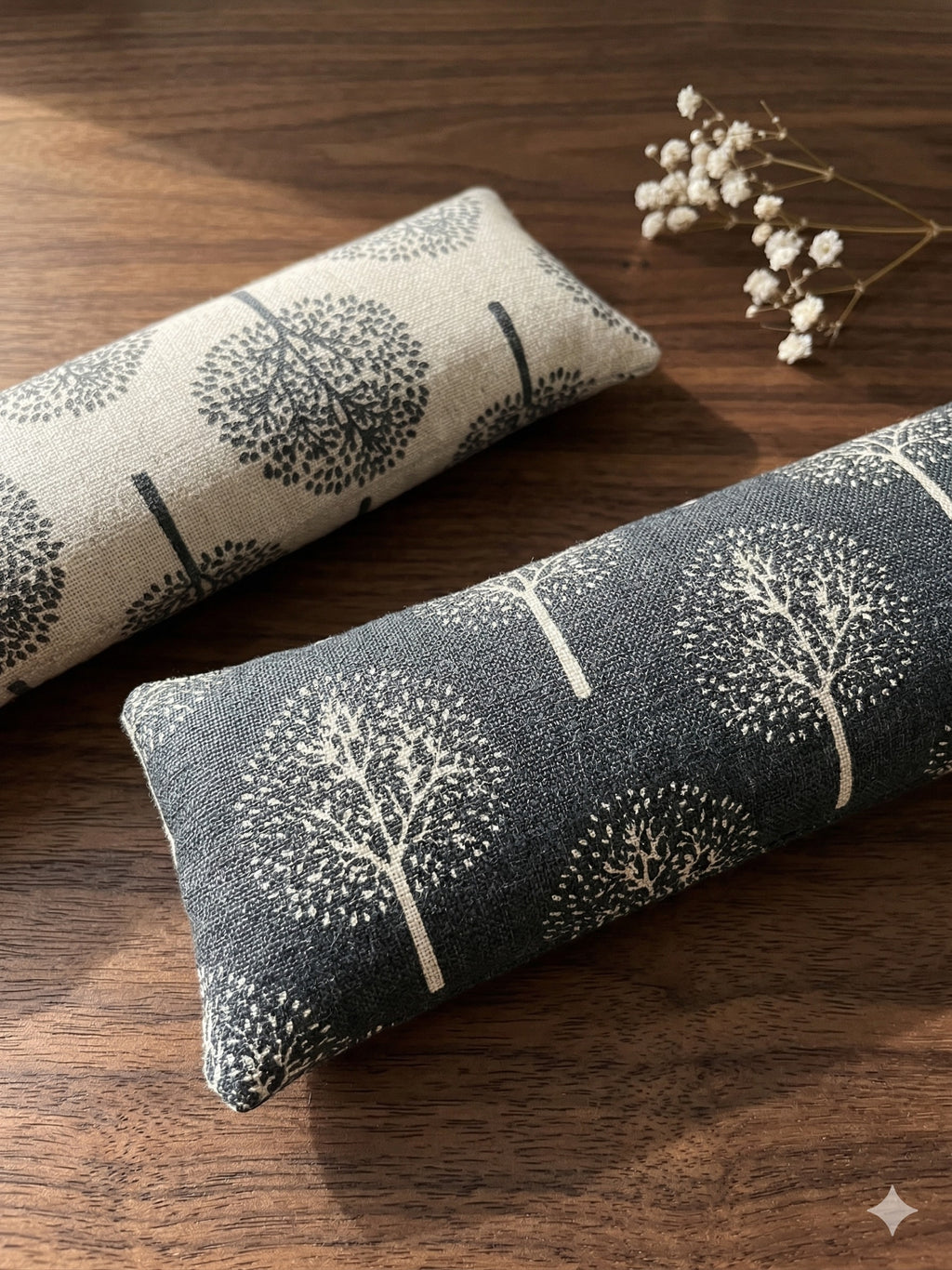 Light and dark tree print wrist rests on a dark wooden table