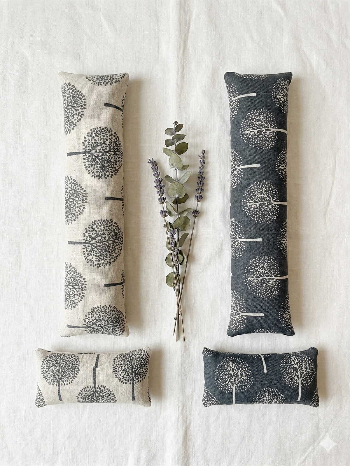 Light and dark tree print keyboard wrist rests laid flat with a sprig of lavender