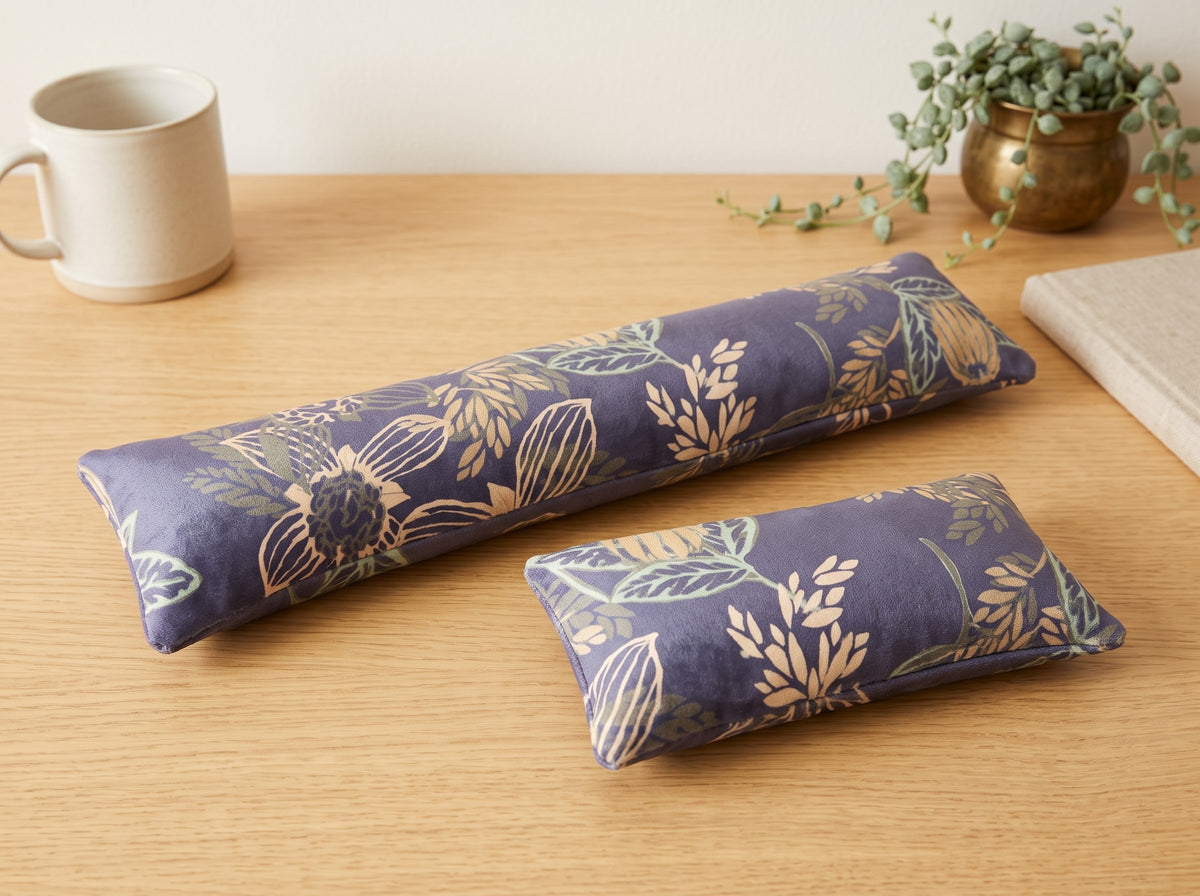 Twilight bloom velvet keyboard and mouse wrist rests on a wooden desk with a potted plant
