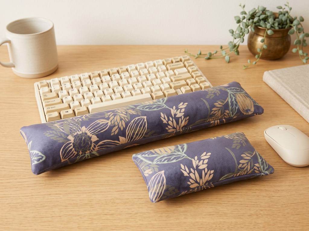 Twilight bloom velvet wrist rests around a keyboard on a wooden desk