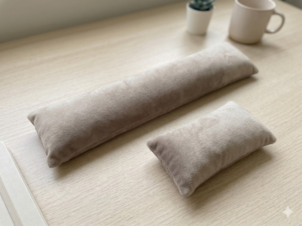 Taupe velvet keyboard wrist rest and mouse wrist rest on a wooden desk