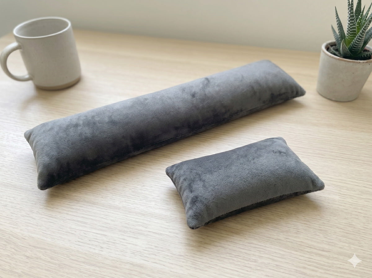 Charcoal velvet keyboard and mouse wrist rests on a wooden desk