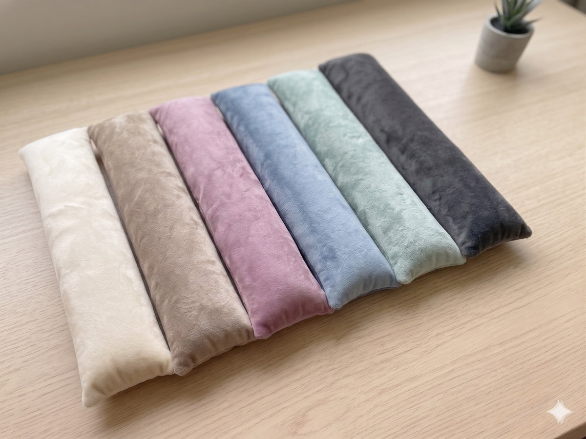 Velvet wrist rests in six colors side by side, cream, taupe, mauve, slate blue, sage green and charcoal