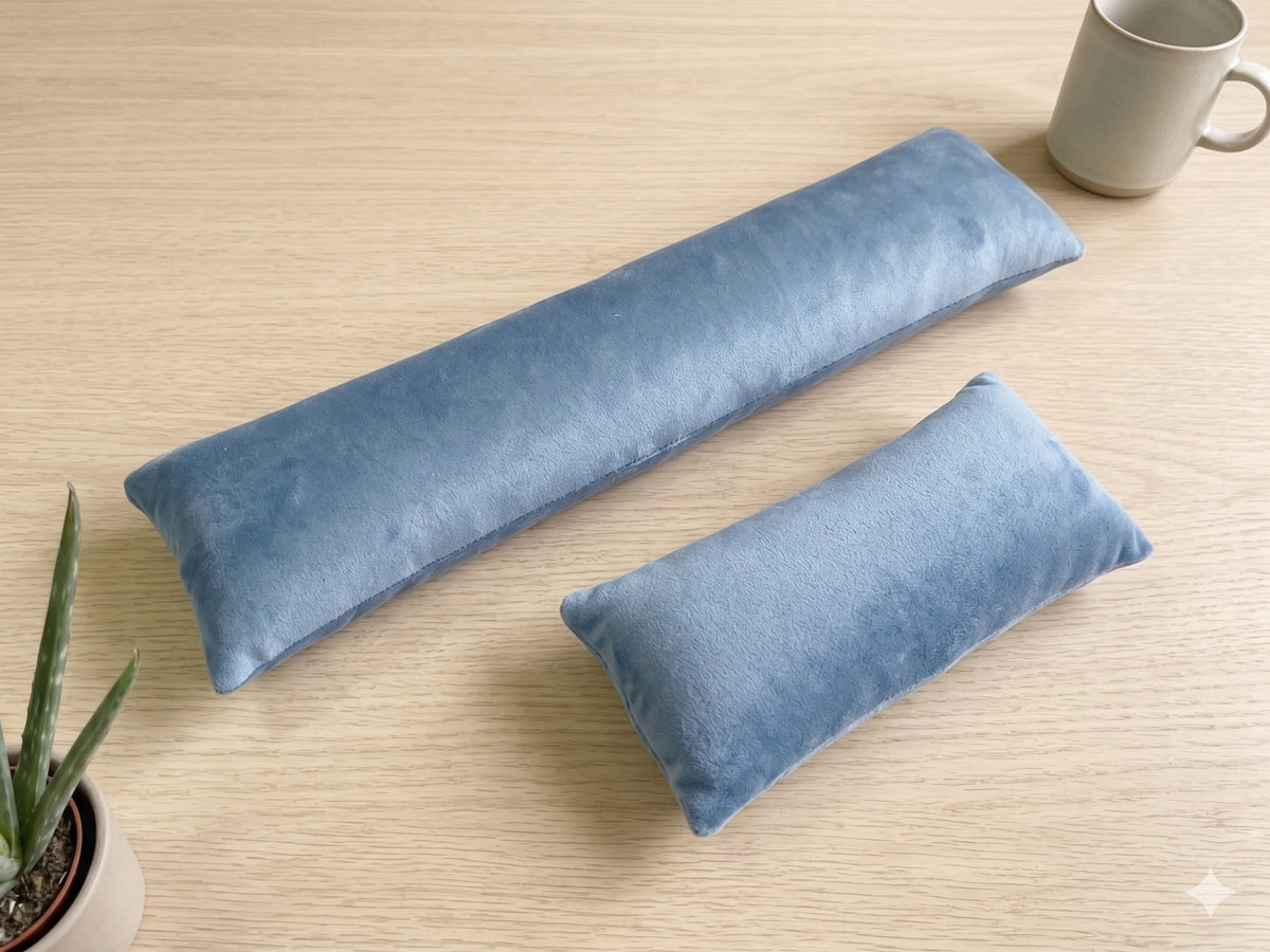 Slate blue velvet keyboard and mouse wrist rests on a wooden desk